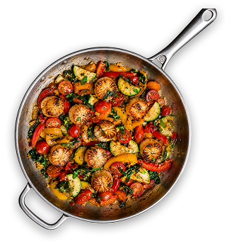 A skillet of roasted vegetables and seared bites, fresh off the stove
